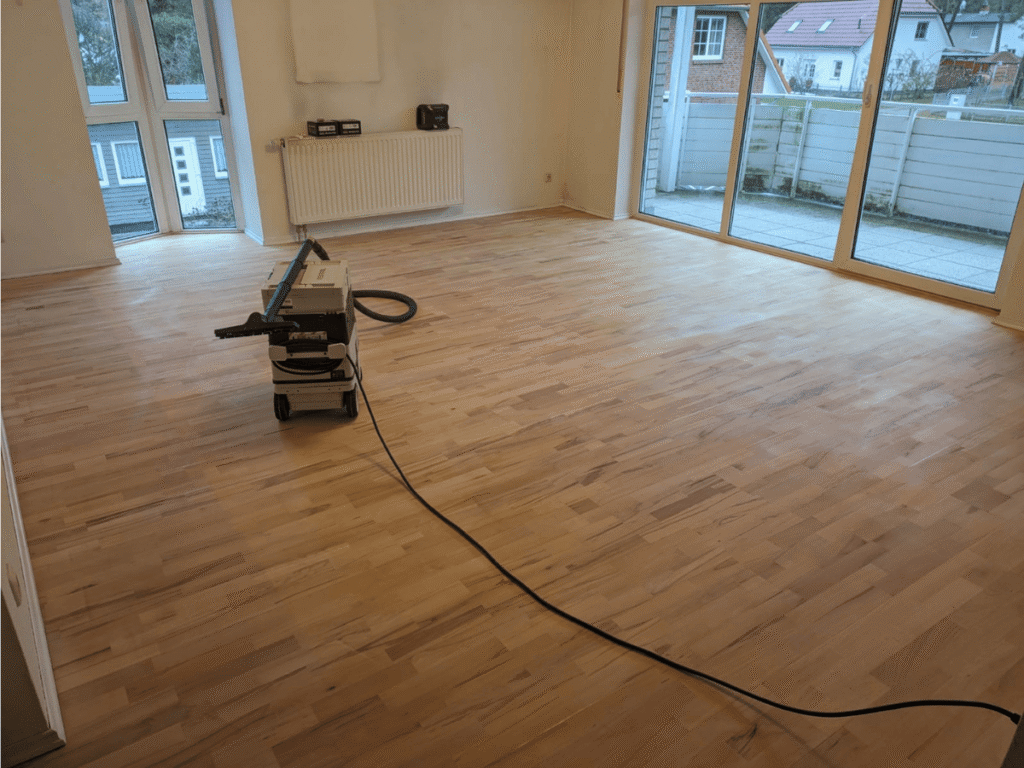 Parkettaufbereitung durch Schleifen und neue Versiegelung, hier Reinigung nach dem ersten Schleifen  von Holzbau K. Jager
